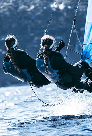 Uomini su una barca a vela con marchio Zhik